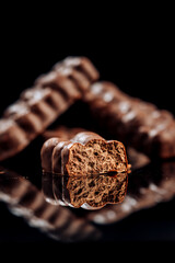 Crunchy chocolate bars with nuts on dark background, ideal for snacks and dessert presentations