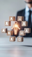 A businessman interacts with a glowing human figure surrounded by wooden blocks representing connections and relationships.