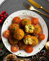 Vegan Chickpea balls coated with panko. Top view table with christmas decoration.