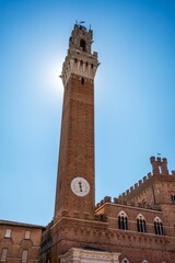 Fototapeta premium Torre del Mangia in Siena under a clear blue sky