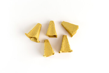 broken pieces of recycle empty egg carton box on a plain background, part of project of paper craft,