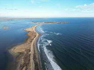 Aerial view of a coastal landscape with a sandy beach.