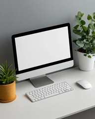 Modern workspace featuring a computer, keyboard, and vibrant plants creating a fresh and inviting atmosphere.