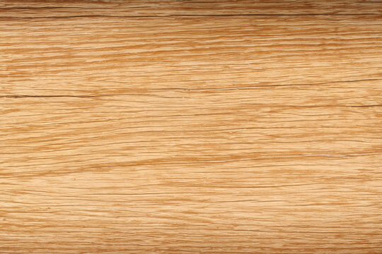 Close-up of a light brown wood grain texture with a natural pattern.
