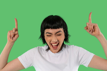 Excited Individual Celebrating With Enthusiasm Against Vibrant Green Backdrop