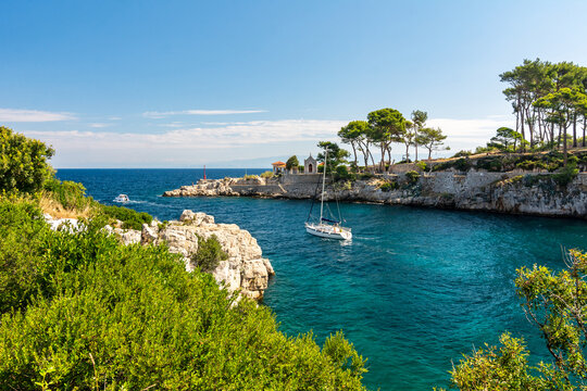 Sailing yacht leaving the beautiful harbour of Veli Losinj, Croatia