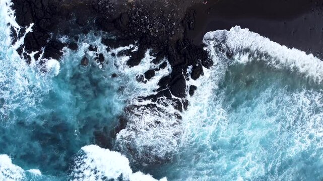 Aerial view of powerful waves crashing on the rocky coastline of Acores, Portugal.