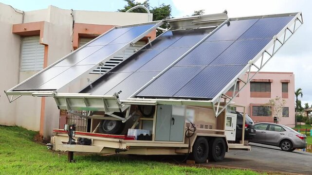 Portable solar panel generators in a garden, by urban buildings during daytime