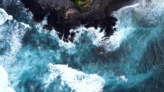 Aerial view of powerful waves crashing on the rocky coastline of Acores, Portugal.