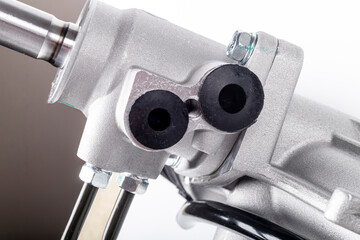 Studio lighting. on a white background, the steering rack of the car. New part.