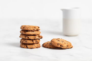 stacked chocolate chip cookies on white background