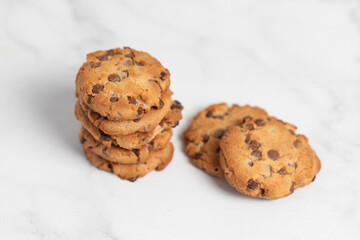 stacked chocolate chip cookies on white background