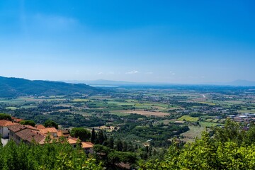 Panoramic view of rural landscape with village and clear blue sky