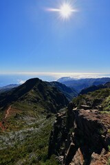 Obraz premium Stunning mountain landscape with bright blue sky and sun, Madeira Island, Portugal