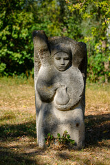The figure of the ancient gods on the stones in the autumn park. Ukraine. Scythian culture