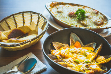Curry Mussels in a bowl and Served with pita bread