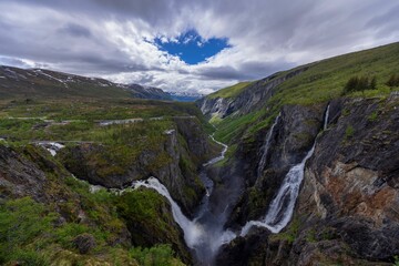 Voringfossen waterfall in Norway's rugged mountain valley.