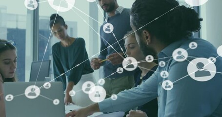 Animation of network of connections with people icons over diverse business people in office