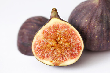 Fresh fig sliced in half closeup. Fruit's intricate texture. Single object isolated on white...