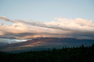 Mountain range at sunset with cloudy sky
