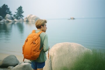 Fototapeta premium Backpacker on the lake shore