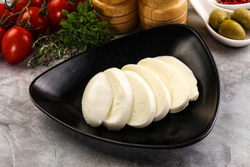 Organic mozzarella cheese slices in the plate