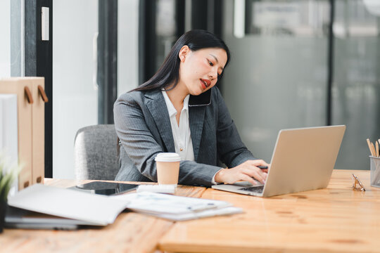 Busy professional woman multitasking at modern office desk