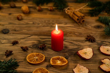 Traditional Czech Christmas on wood decoration with twig, candle, apple, orange, fruit