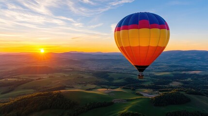 Obraz premium hot air balloon floating over a picturesque landscape at sunrise, with the colorful balloon