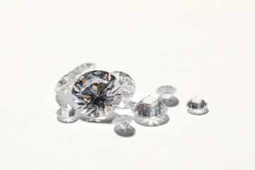 Many beautiful shiny diamonds on white background, closeup