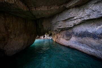 Scenic view of a cave opening to the sea with clear blue waters