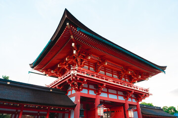 Fototapeta premium Traditional Japanese Temple with Vibrant Red Architecture on a Sunny Day