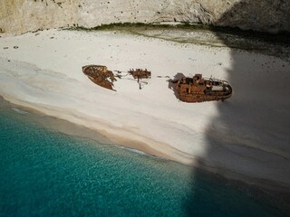 Aerial view of shipwreck remains on the sandy beach of Zakynthos Island on a sunny day in Greece