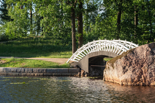 arched wooden pedestrian bridge in the park