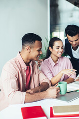 Positive men and woman reading text publications in social networks and smiling from funny content connected to free wifi internet on cellular phone, happy colleagues watching comedy video via app