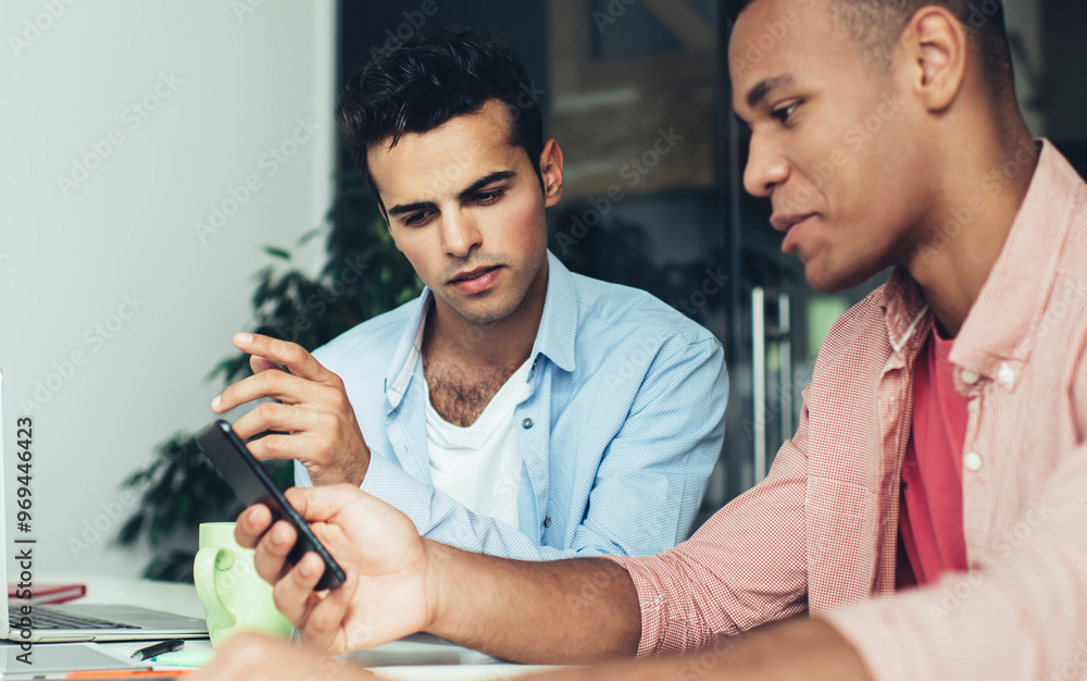 Poster two millennials reading received email message during mobile chatting in office interior connecting 