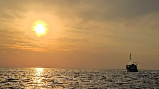 Boat floting with beautiful sunset in the sea