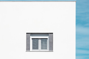 Window on the wall. Close up of a house exterior.