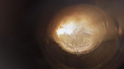 A unique perspective view inside the confined space where welding is happening, emphasizing the concentration, the bright spark, and swirling smoke, portraying the intricate process of metal joining.