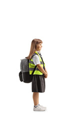 Full length profile shot of a schoolgirl in a uniform and reflective safety vest