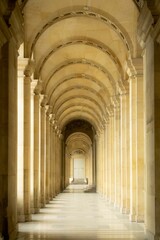 Elegant corridor with arches and columns in a historic building.