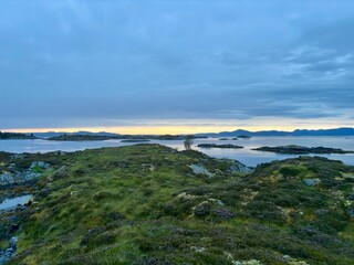 Sunrise over the island of Smoela, Norway, on a cloudy morning