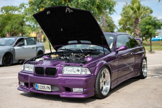 Spectacular purple BMW E36 with the hood open showing its powerful modified inline 6-cylinder