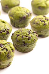 Fototapeta premium Bright Green Spinach Chocolate Chip Mini Muffins Isolated on a White Background
