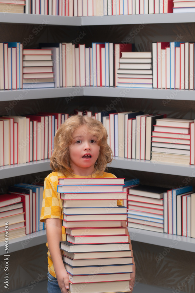 Poster Amazed school kid hold stack of books. Nerd pupil. Back to school. School kid pupil studying in school library. Child reading book in library on bookshelf background.