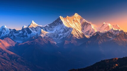 Obraz premium A breathtaking view of snow-capped mountain peaks bathed in the golden light of sunrise, with a clear blue sky.