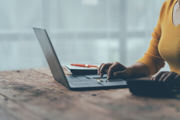 Fototapeta premium Financial Focus: Woman Analyzing Data on Laptop