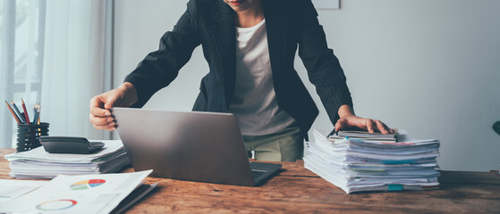 Overwhelmed: Businesswoman Grappling with Paperwork Overload at Office Desk 