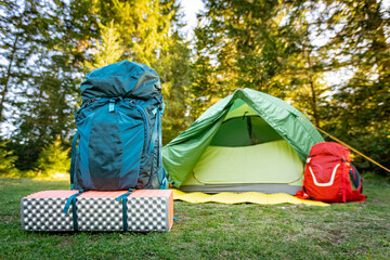 Camping with a tent and cooking equipment in the mountains.
