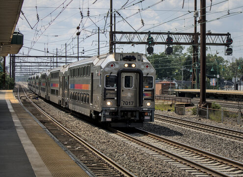 New York City bound NJT New Jersey Transit commuter rail train arriving on track at Rahway station in NJ.